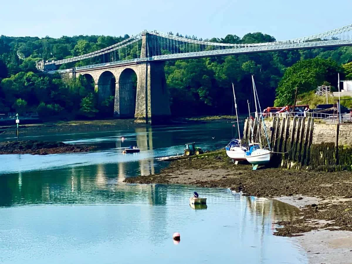 Two yachts aground in front of Menai Bridge