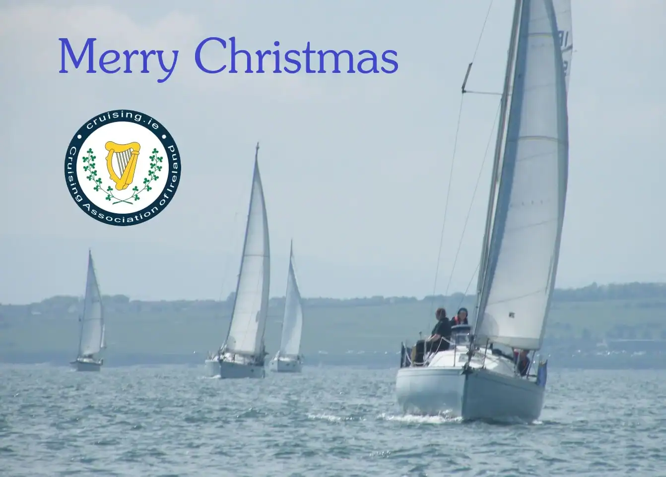 Yachts sailing in company with CAI logo and text 'Merry Christmas'